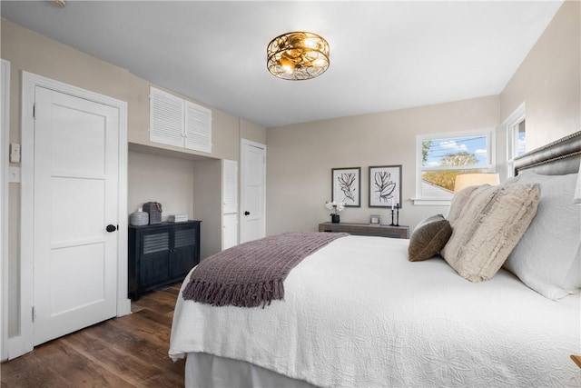 bedroom with dark wood finished floors