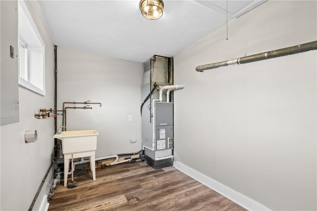 utility room featuring heating unit
