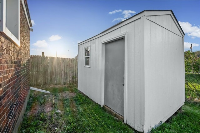 view of shed featuring fence