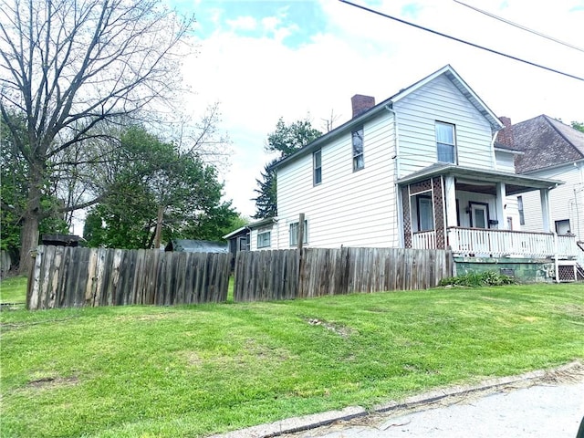 view of property exterior featuring fence, a chimney, cooling unit, a lawn, and covered porch
