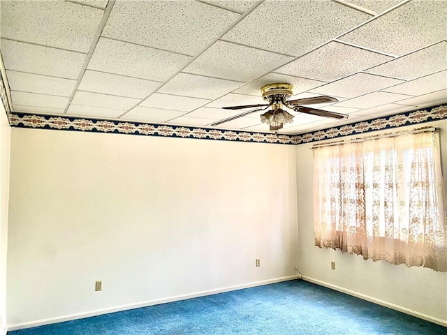 empty room featuring baseboards, a ceiling fan, and carpet