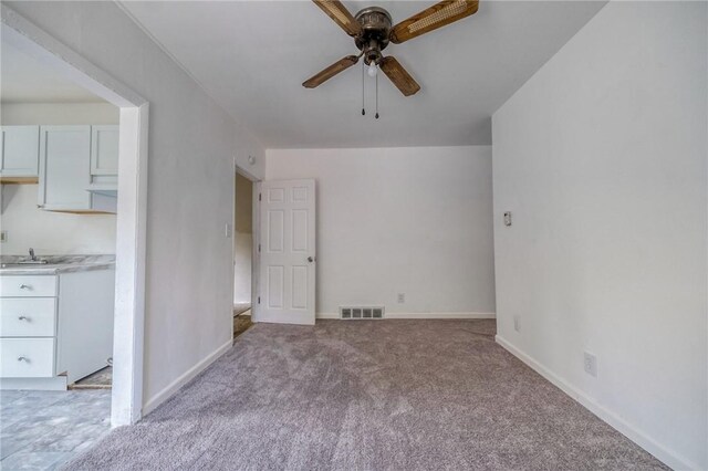 616 Evans Ave, Mckeesport, PA 15132 - unfurnished living room featuring ceiling fan, carpet, and baseboards