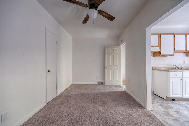 616 Evans Ave, Mckeesport, PA 15132 - empty room featuring a ceiling fan, light colored carpet, baseboards, and a sink
