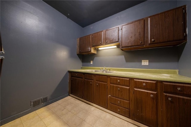 616 Evans Ave, Mckeesport, PA 15132 - kitchen featuring a sink, light countertops, light floors, and baseboards