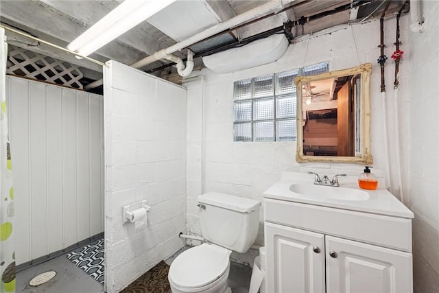 bathroom featuring vanity, concrete floors, and toilet