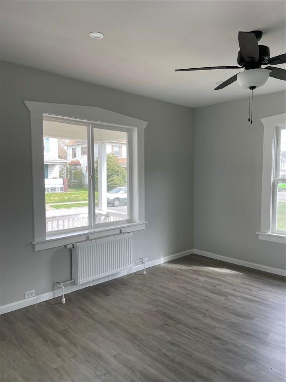 280 Spruce, Sharon, PA 16146 - empty room with radiator, baseboards, a ceiling fan, and wood finished floors