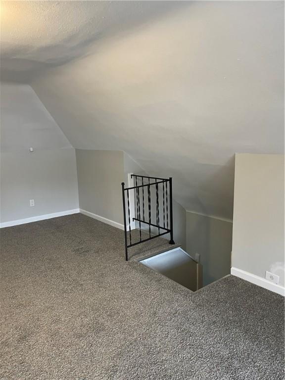 280 Spruce, Sharon, PA 16146 - additional living space featuring baseboards, dark colored carpet, a textured ceiling, and lofted ceiling