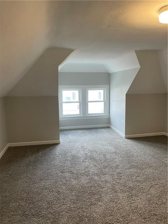280 Spruce, Sharon, PA 16146 - additional living space with baseboards, carpet, and vaulted ceiling
