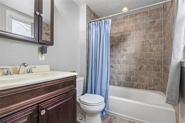 bathroom with vanity, shower / bath combo with shower curtain, and toilet