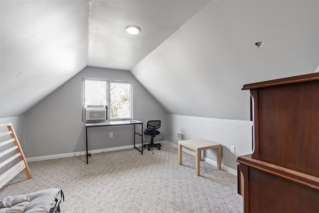 office with visible vents, cooling unit, carpet floors, baseboards, and vaulted ceiling