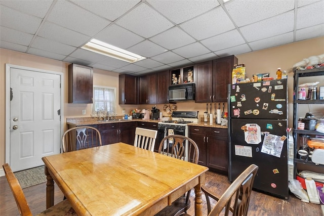 403 Ormsby Ave, Mount Oliver, PA 15210 - kitchen featuring dark brown cabinets, dark wood-style floors, light countertops, a sink, and black appliances