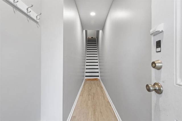 hallway with baseboards and light wood-style flooring