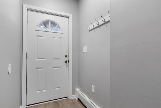 doorway featuring light wood-style floors and baseboards