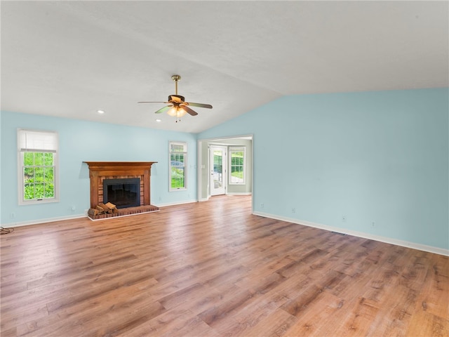 297 Rainey Rd, Somerset Twp, PA 15330 - unfurnished living room featuring light wood-type flooring, ceiling fan, a healthy amount of sunlight, and a fireplace