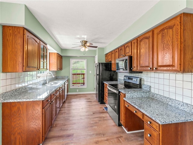 297 Rainey Rd, Somerset Twp, PA 15330 - kitchen with a ceiling fan, tasteful backsplash, a sink, light wood finished floors, and stainless steel appliances