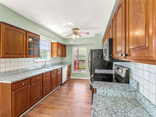 297 Rainey Rd, Somerset Twp, PA 15330 - kitchen featuring appliances with stainless steel finishes, brown cabinetry, and light wood-type flooring