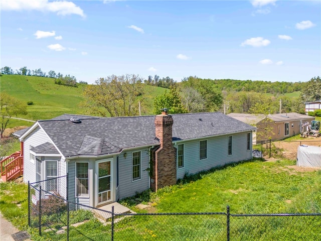 297 Rainey Rd, Somerset Twp, PA 15330 - rear view of house with a fenced backyard, roof with shingles, and a chimney