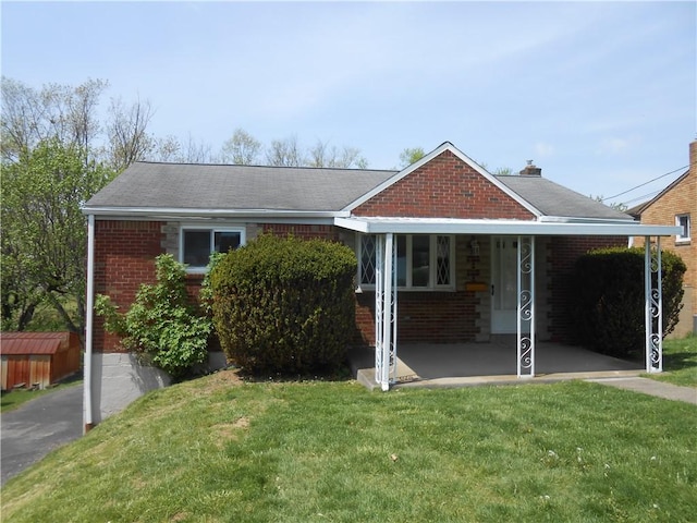 single story home with brick siding and a front lawn