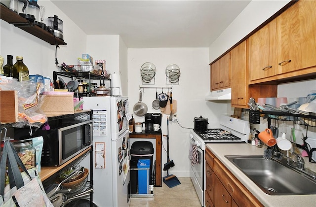 kitchen featuring a sink, white appliances, light countertops, brown cabinetry, and under cabinet range hood