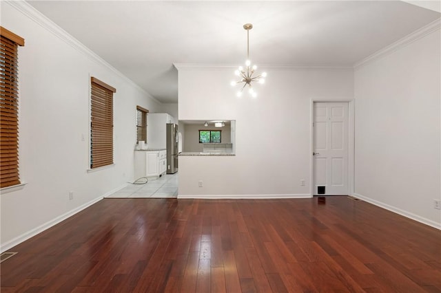 unfurnished dining area with hardwood / wood-style floors, baseboards, ornamental molding, and a notable chandelier