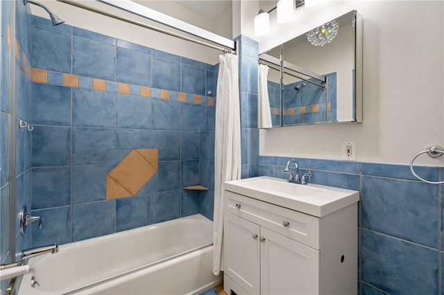 bathroom featuring vanity, tile walls, and shower / bath combo with shower curtain