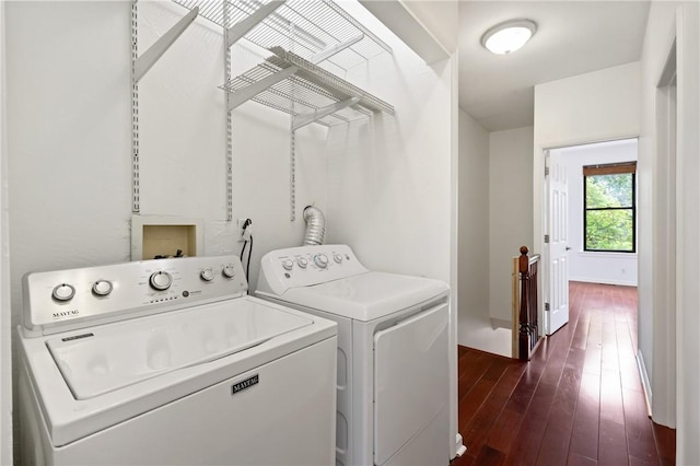 laundry room featuring baseboards, washing machine and dryer, and dark wood-type flooring