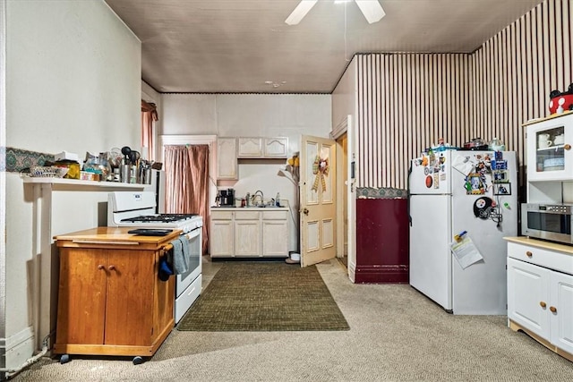 101 Clara St, Millvale, PA 15209 - kitchen with carpet flooring, a sink, white appliances, light countertops, and a ceiling fan