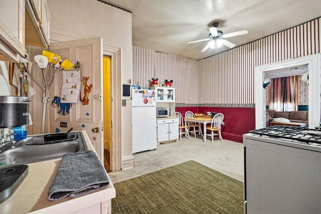 101 Clara St, Millvale, PA 15209 - kitchen featuring baseboards, a ceiling fan, carpet flooring, and white appliances