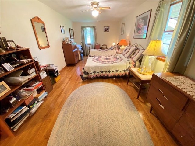 bedroom with light wood-style floors and ceiling fan