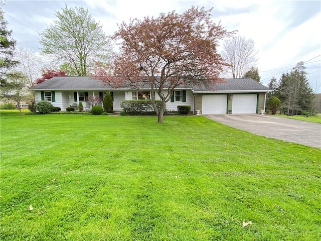 ranch-style home with a garage, a front lawn, and aphalt driveway