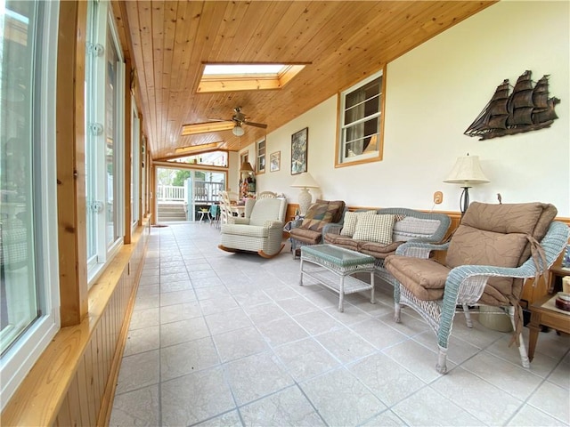 tiled living room with wood ceiling, lofted ceiling with skylight, and ceiling fan