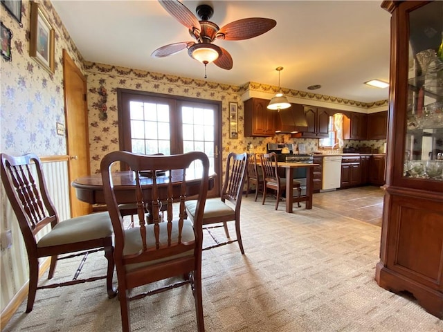 dining room featuring plenty of natural light, wallpapered walls, and ceiling fan