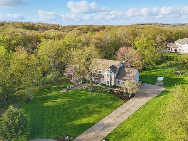 birds eye view of property with a wooded view