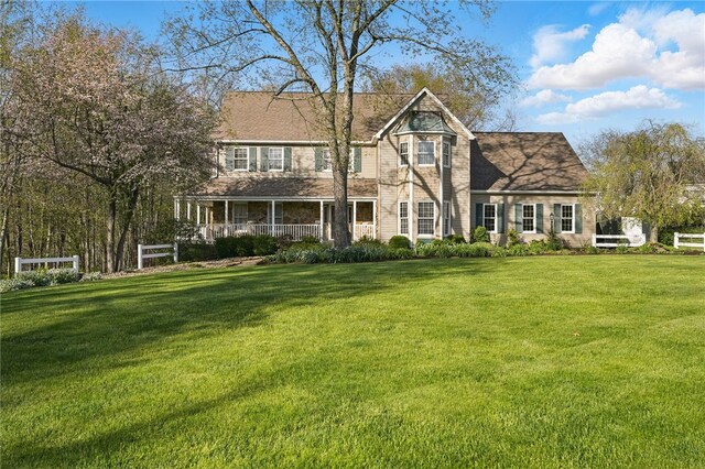 view of front of property with a porch and a front yard