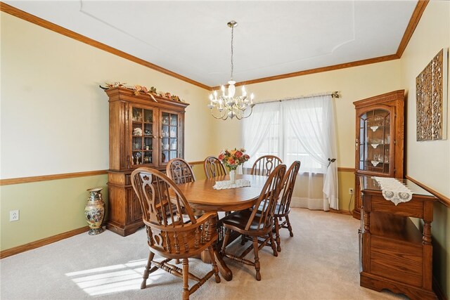 dining space with light colored carpet, baseboards, crown molding, and a chandelier