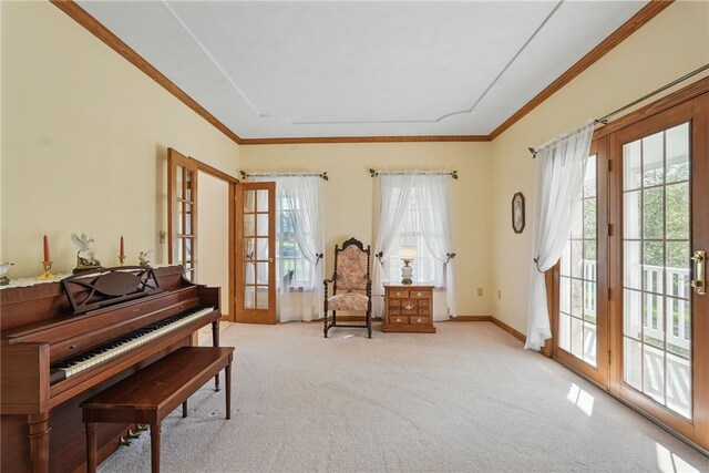 sitting room featuring carpet floors, crown molding, a wealth of natural light, and french doors