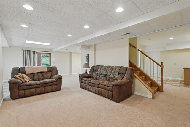 carpeted living area featuring visible vents, stairs, baseboards, recessed lighting, and a paneled ceiling
