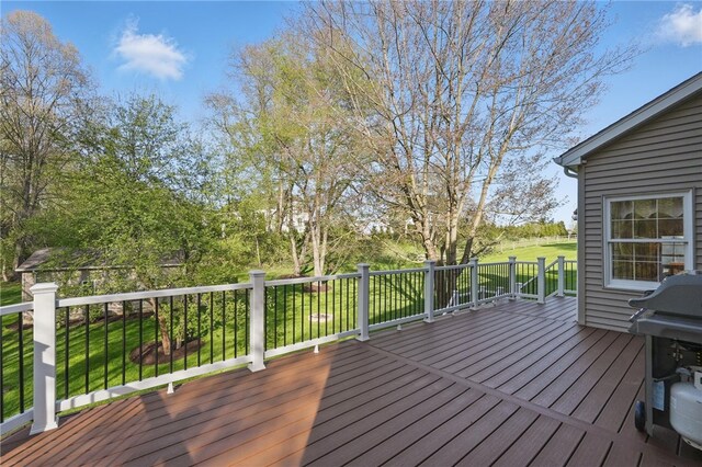 deck featuring a lawn and grilling area