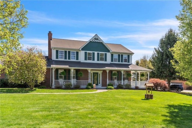 view of front of home with a porch, a chimney, and a front yard