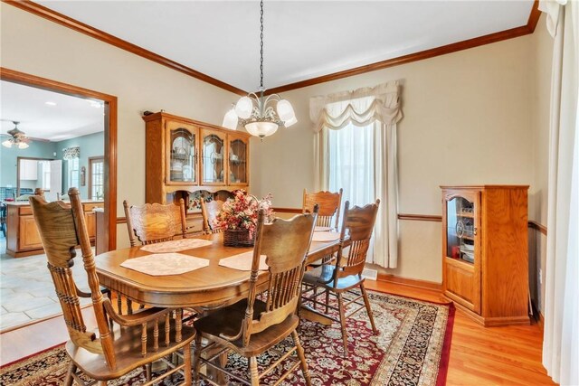 204 Salt Works Rd, Lancaster Twp, PA 16037 - dining room with crown molding, ceiling fan, a chandelier, and light wood finished floors