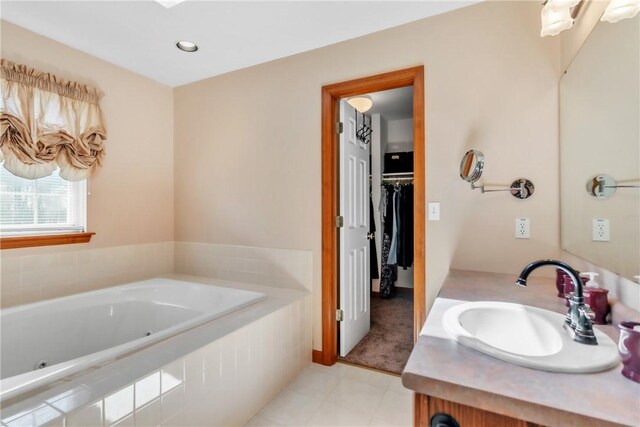 204 Salt Works Rd, Lancaster Twp, PA 16037 - bathroom featuring a jetted tub, vanity, tile patterned floors, and a walk in closet