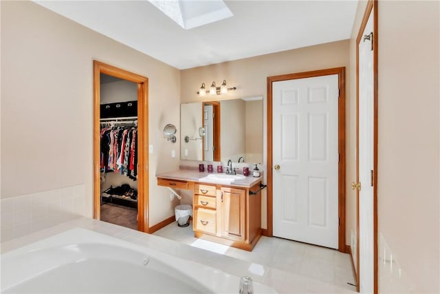 204 Salt Works Rd, Lancaster Twp, PA 16037 - bathroom with vanity, a bath, a walk in closet, and a skylight