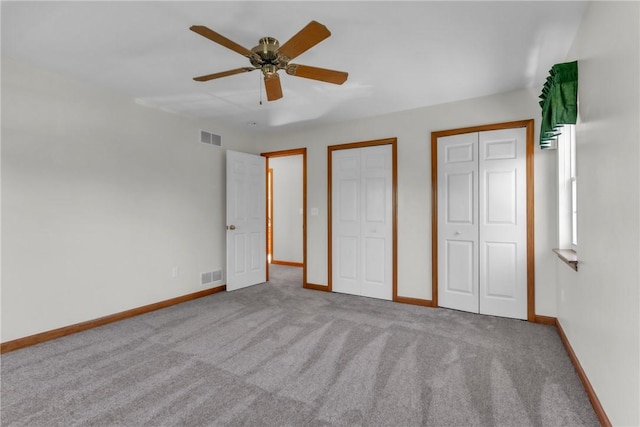 204 Salt Works Rd, Lancaster Twp, PA 16037 - unfurnished bedroom featuring multiple closets, carpet, and a ceiling fan