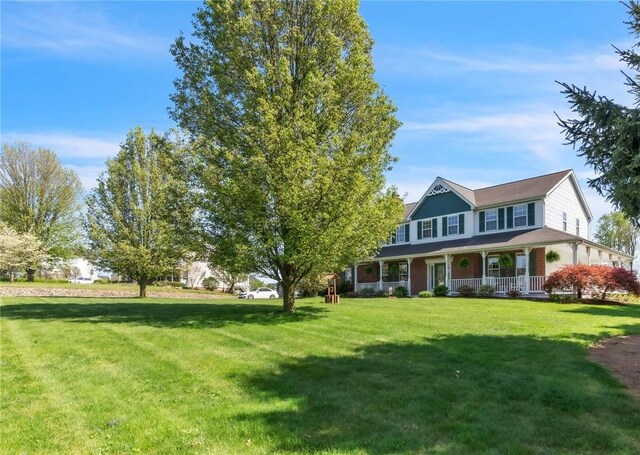 204 Salt Works Rd, Lancaster Twp, PA 16037 - view of front of property featuring covered porch, a front yard, and brick siding