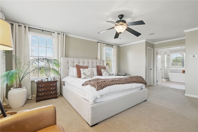bedroom featuring ornamental molding, carpet flooring, ensuite bath, and ceiling fan