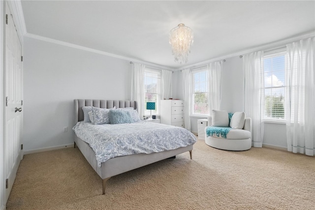 carpeted bedroom with baseboards, crown molding, and a chandelier