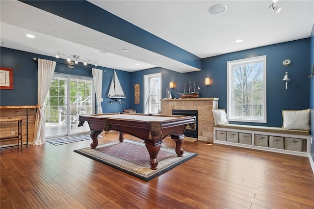 recreation room with billiards, a fireplace, rail lighting, wood finished floors, and recessed lighting