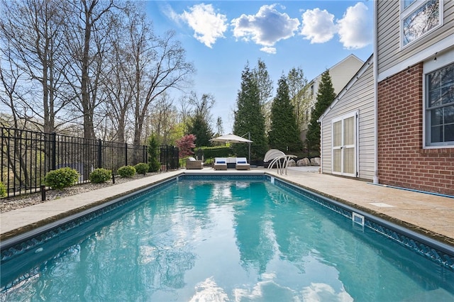 view of pool with a fenced in pool, fence, and a patio