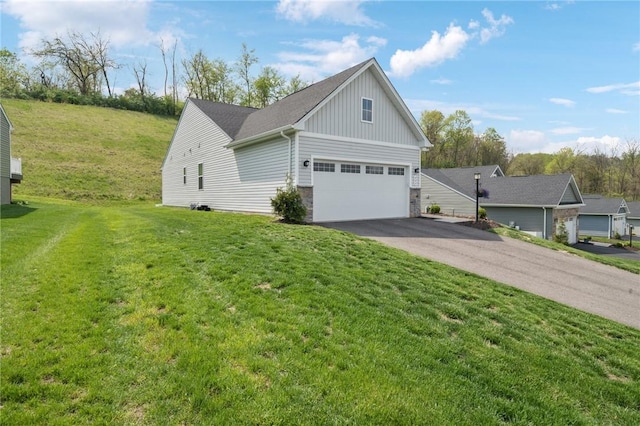 406 Spruce Ln, Chartiers, PA 15342 - view of side of home featuring board and batten siding, a lawn, driveway, and stone siding