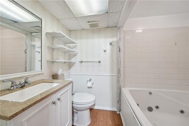 413 Pasadena Dr, Port Vue, PA 15133 - full bathroom with visible vents, wainscoting, wood finished floors, vanity, and toilet